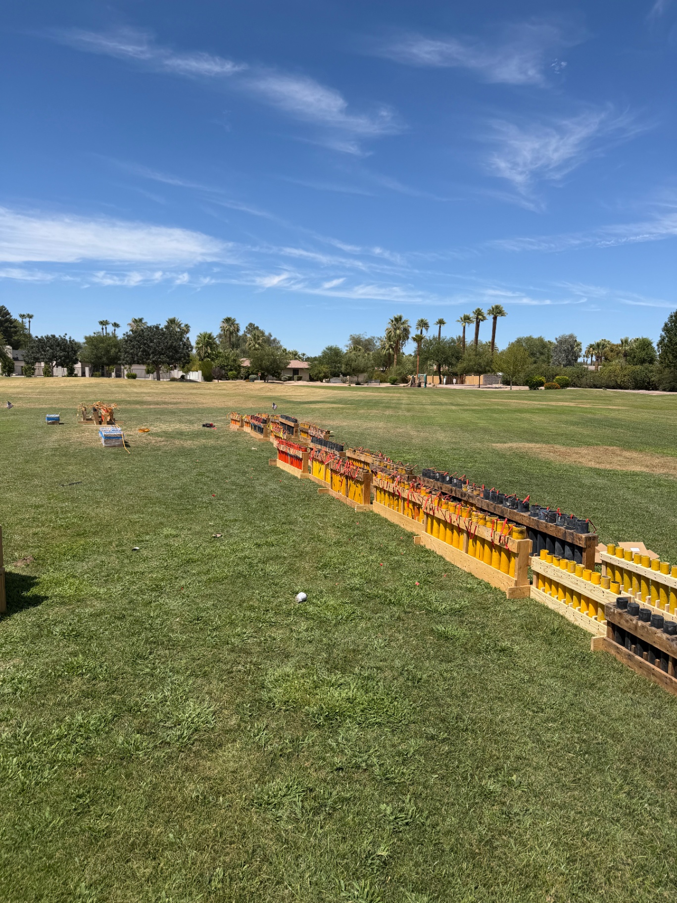 Rows of professional mortar racks staged during daylight setup at a Southwest fireworks display site