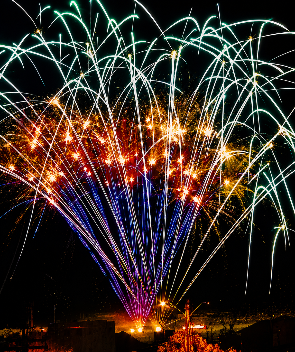 Multi-color aerial fireworks burst from a professional display